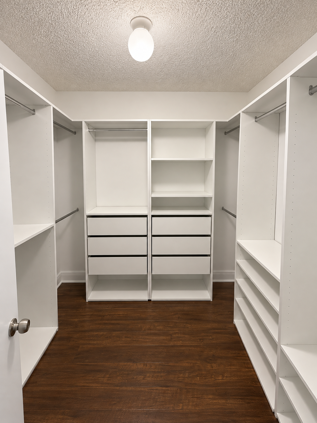 Spacious white walk-in closet with storage on three walls