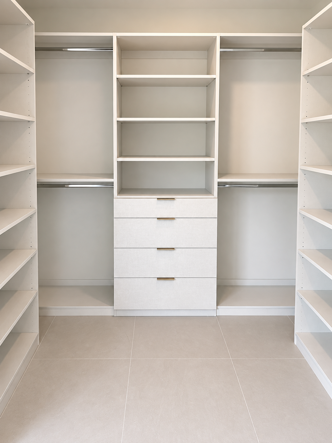 White walk-in closet with central drawers and adjustable shelving