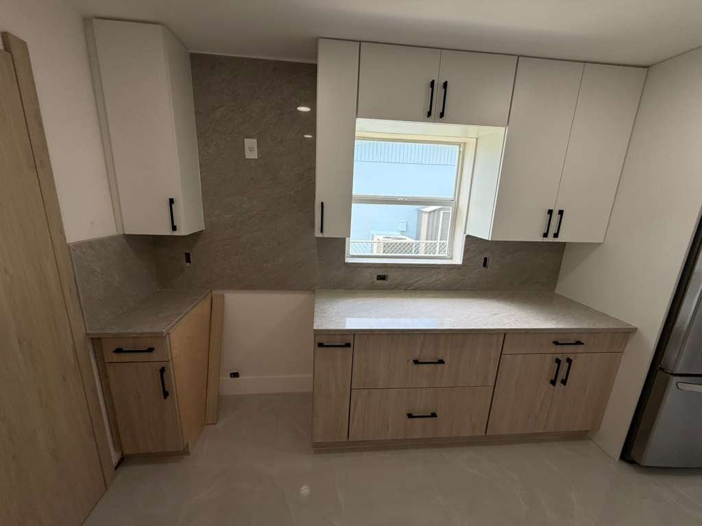 Two-tone custom kitchen with light upper cabinets
