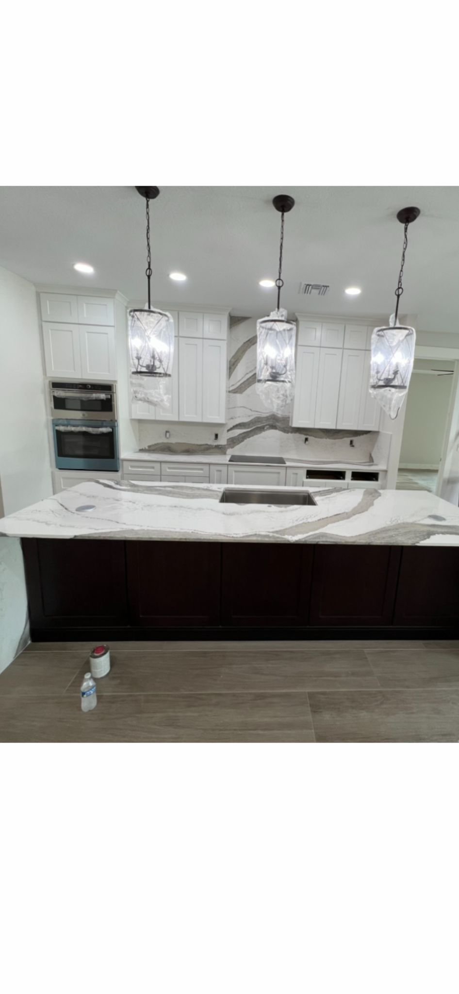 White custom kitchen with dramatic stone surfaces